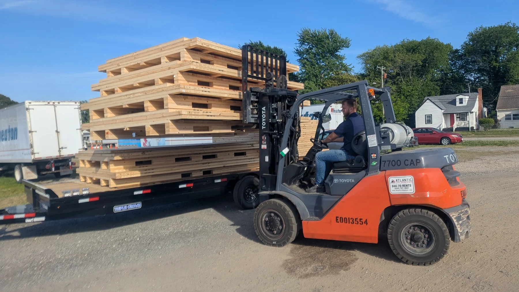 Forklift handling flat-pack shipping crate components