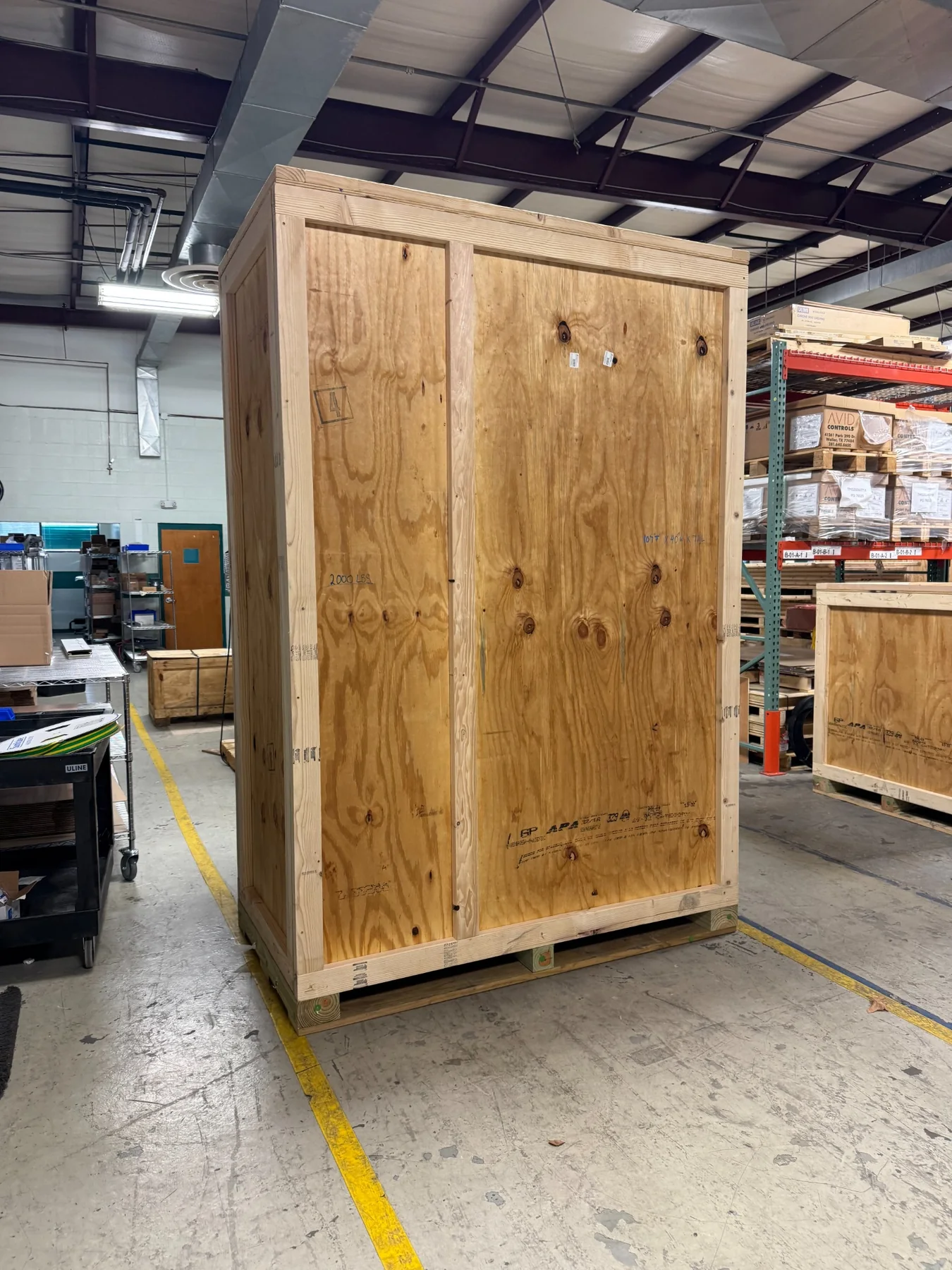 Worker assembling a custom wood shipping crate